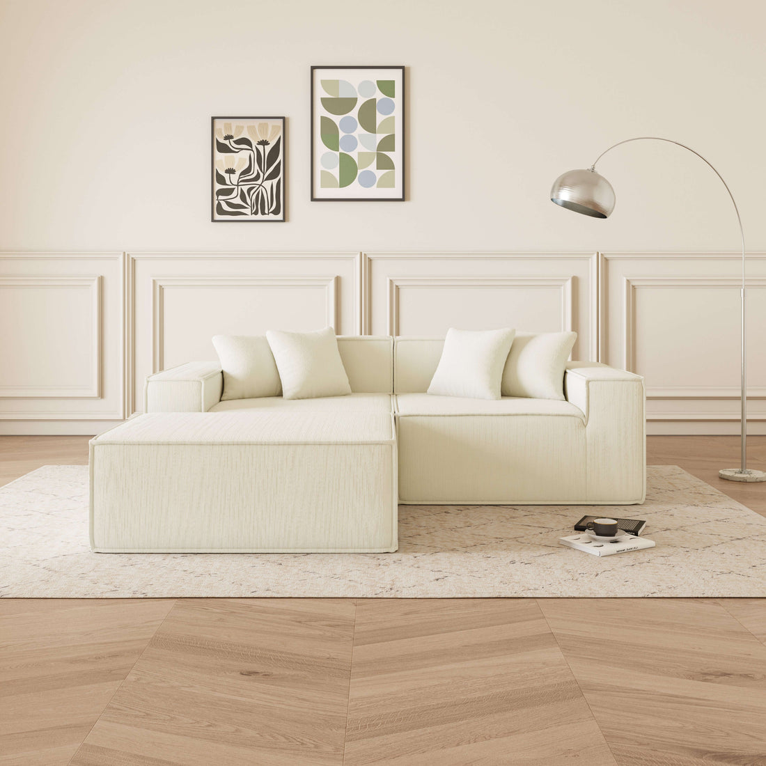 Cube - Sofá Modular 2 Plazas + Puff en Pana Beig en ambiente moderno con lámpara y arte en paredes.